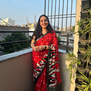 Bone Voyage red cotton dog print saree with paw print and bone motifs, illustrated dog border and black zari stripe pallu, Zoomies Collection
