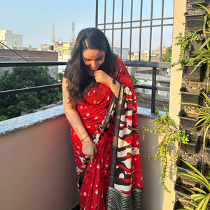 Bone Voyage red cotton dog print saree with paw print and bone motifs, illustrated dog border and black zari stripe pallu, Zoomies Collection