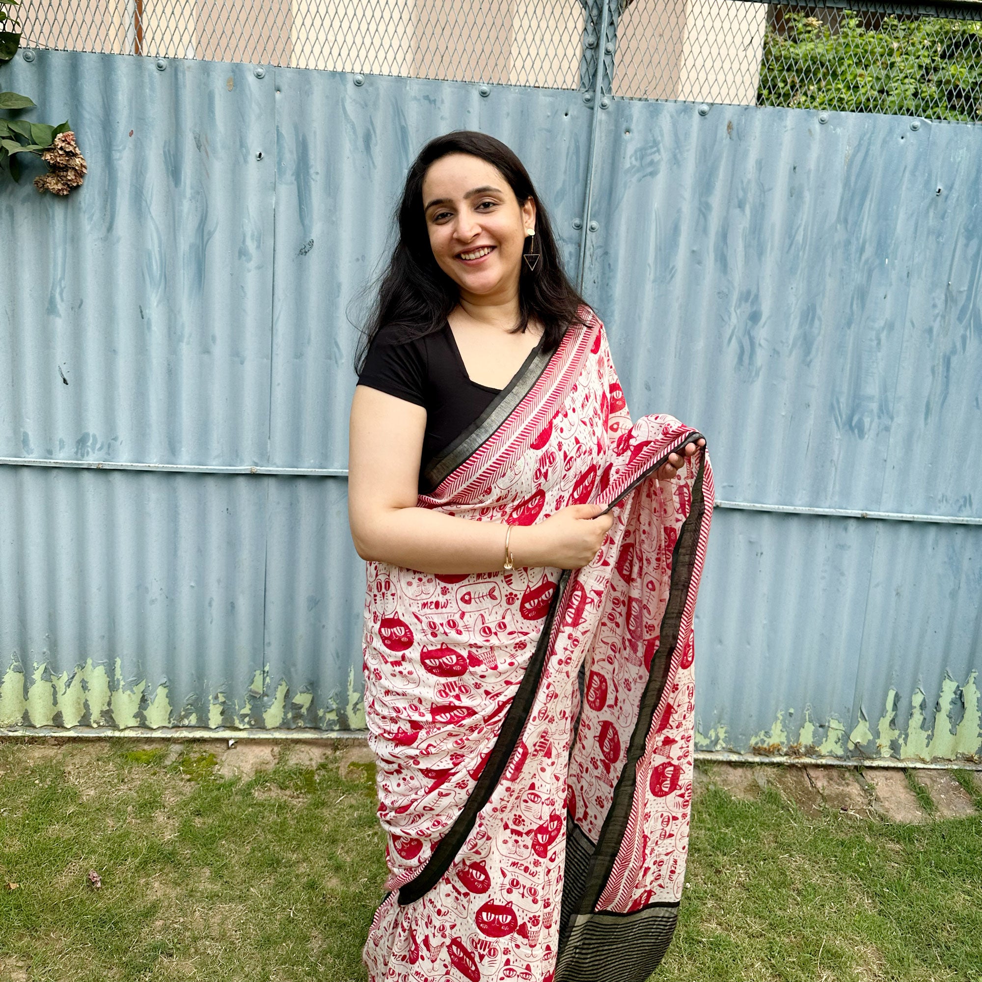 Founder wearing Cat Got Your Heart cotton saree in red and white cat print with black border, styled with black blouse, by The Thread Weavers