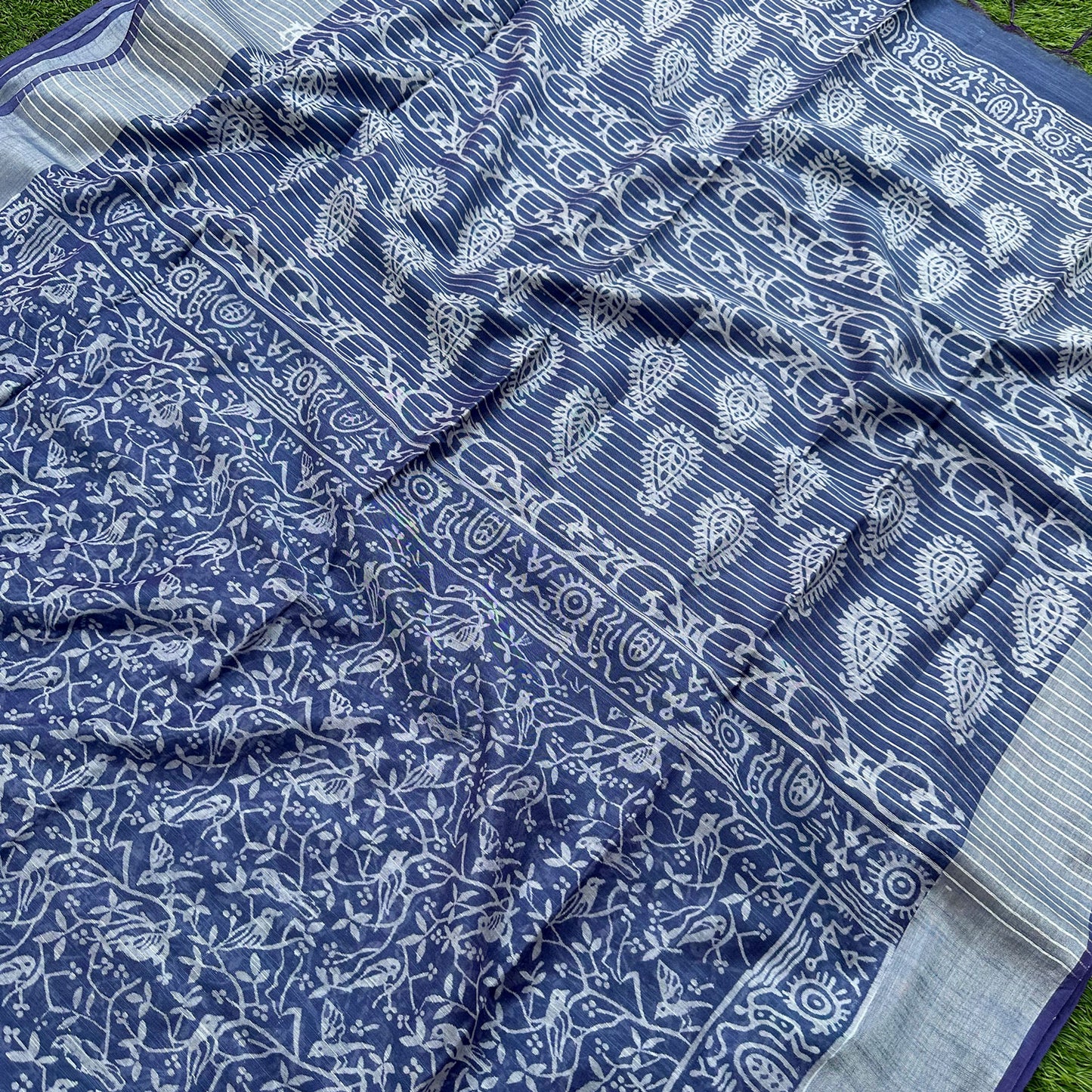 Closeup of Mughal jaal bird and flowering vine block print on indigo cotton silk on the body and paisley on the pallu – Chakori