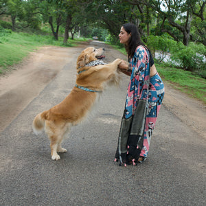 Model wearing Dog Mom Actually pink blue patchwork dog print saree with illustrated dog panels and black zari pallu, Zoomies Collection Thread Weavers. Pablo her baby in the The Thread Weaver's Bandana