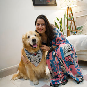 Model wearing Dog Mom Actually pink blue patchwork dog print saree with illustrated dog panels and black zari pallu, Zoomies Collection Thread Weavers. Pablo her baby in the The Thread Weaver's Bandana