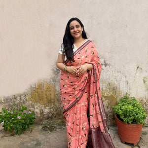 Founder wearing Ears First coral cotton beagle print saree with daisy florals and dark maroon zari pallu paired with white blouse, Zoomies Collection by The Thread Weavers