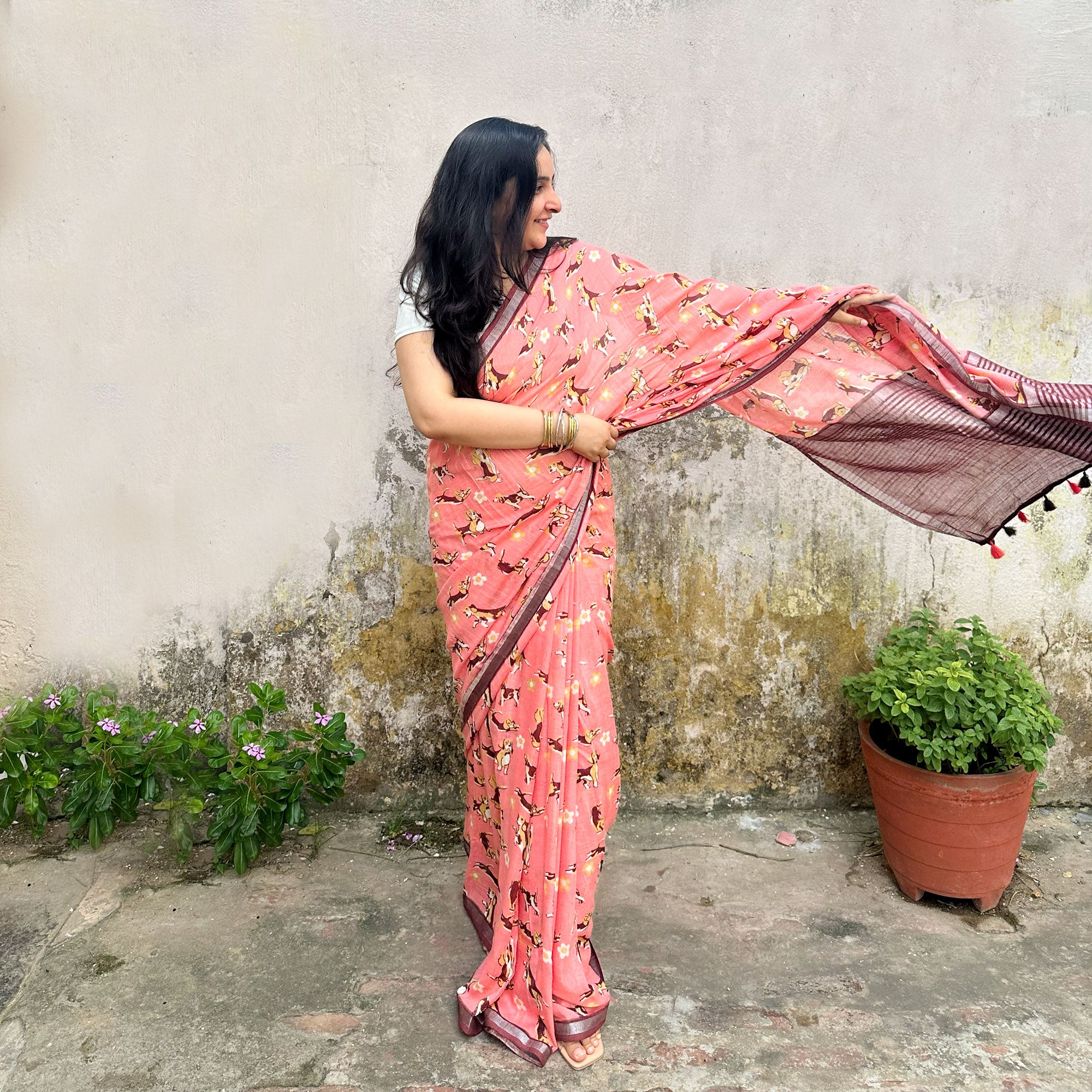Founder wearing Ears First coral cotton beagle print saree with daisy florals and dark maroon zari pallu paired with white blouse, Zoomies Collection by The Thread Weavers