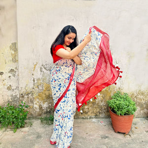 Founder wearing Purr-suasion ivory cotton saree with blue illustrated cat crowd print and bold red zari pallu paired with red blouse, Zoomies Collection by Thread Weavers