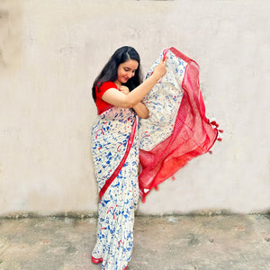 Founder wearing Purr-suasion ivory cotton saree with blue illustrated cat crowd print and bold red zari pallu paired with red blouse, Zoomies Collection by Thread Weavers