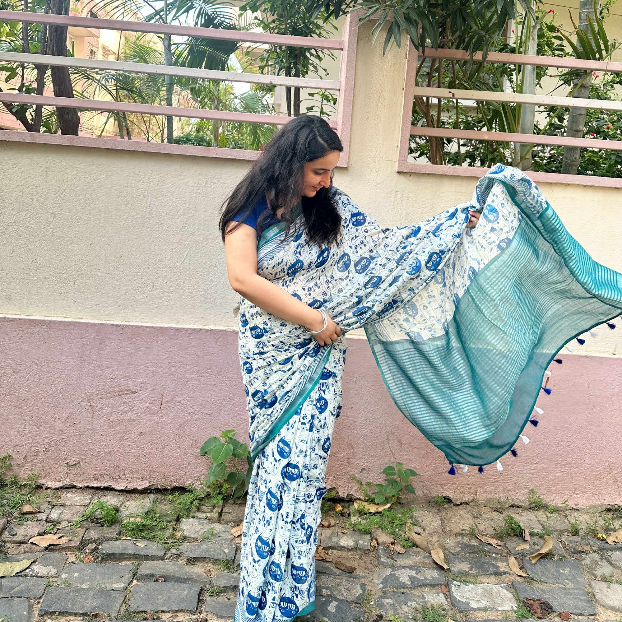Founder wearing Catsablanca ivory cotton saree with navy meow cat face print, chevron border and teal zari pallu, Zoomies Collection by Thread Weavers
