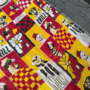 Who Let The Dogs Dress Up yellow red patchwork dog print saree closeup with illustrated dog panels and black zari pallu, Zoomies Collection TTW