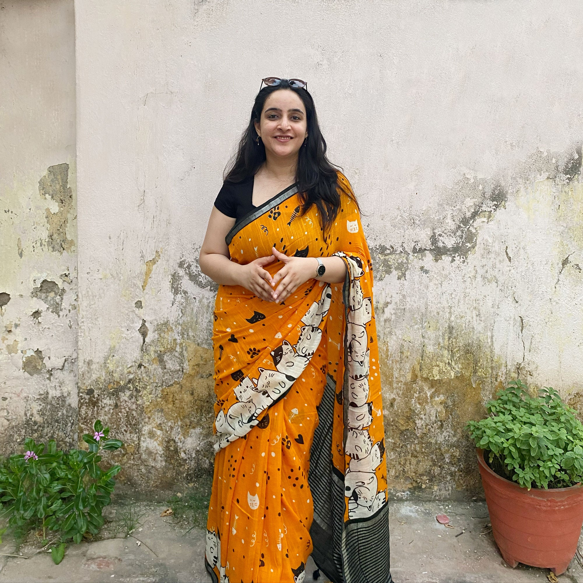 Founder wearing Amber & Aloof amber cotton cat print saree with fishbone motifs, sleeping cat border and black zari pallu paired with a black blouse, Zoomies Collection TTW