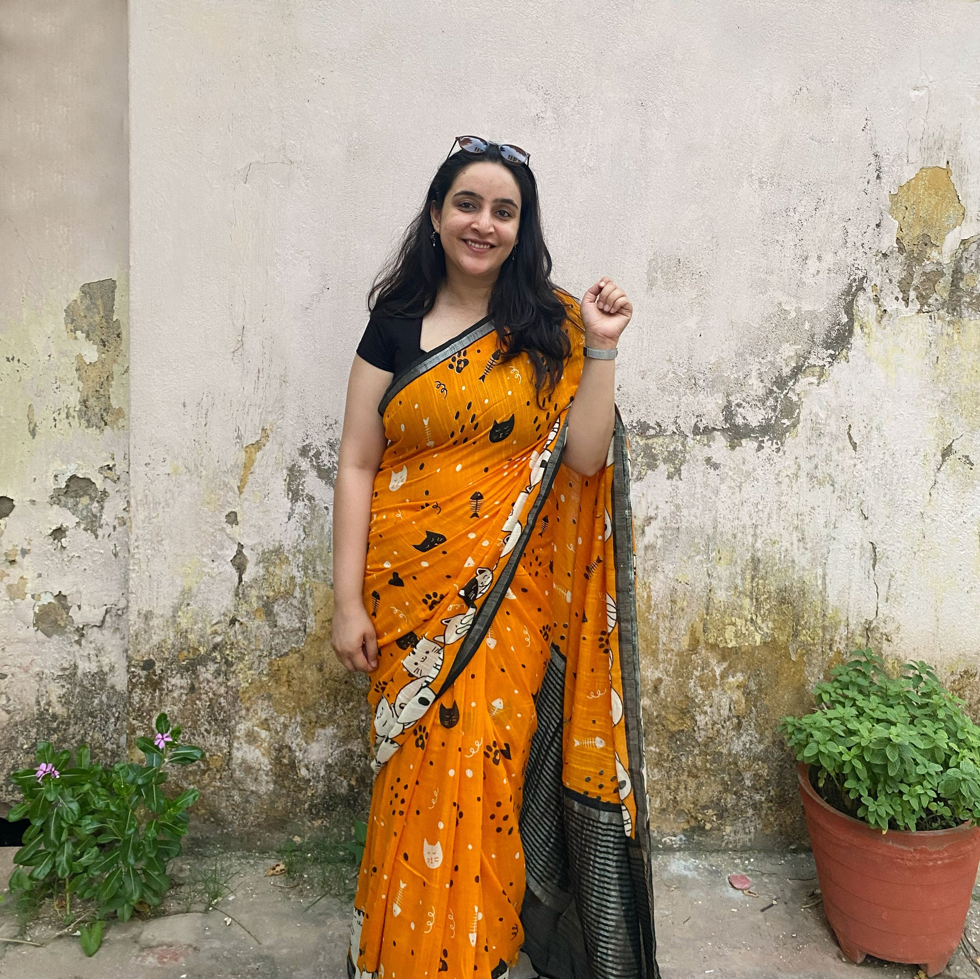 Founder wearing Amber & Aloof amber cotton cat print saree with fishbone motifs, sleeping cat border and black zari pallu paired with a black blouse, Zoomies Collection TTW