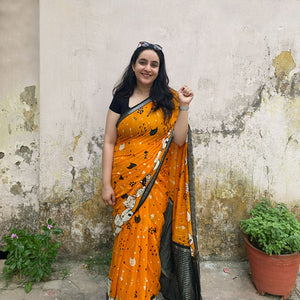 Founder wearing Amber & Aloof amber cotton cat print saree with fishbone motifs, sleeping cat border and black zari pallu paired with a black blouse, Zoomies Collection TTW