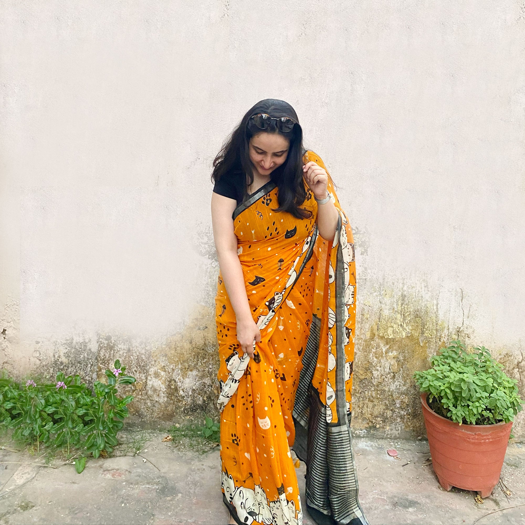 Founder wearing Amber & Aloof amber cotton cat print saree with fishbone motifs, sleeping cat border and black zari pallu paired with a black blouse, Zoomies Collection TTW