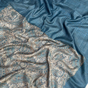 Close-up of blue paisley motifs on a tussar base and blue pallu