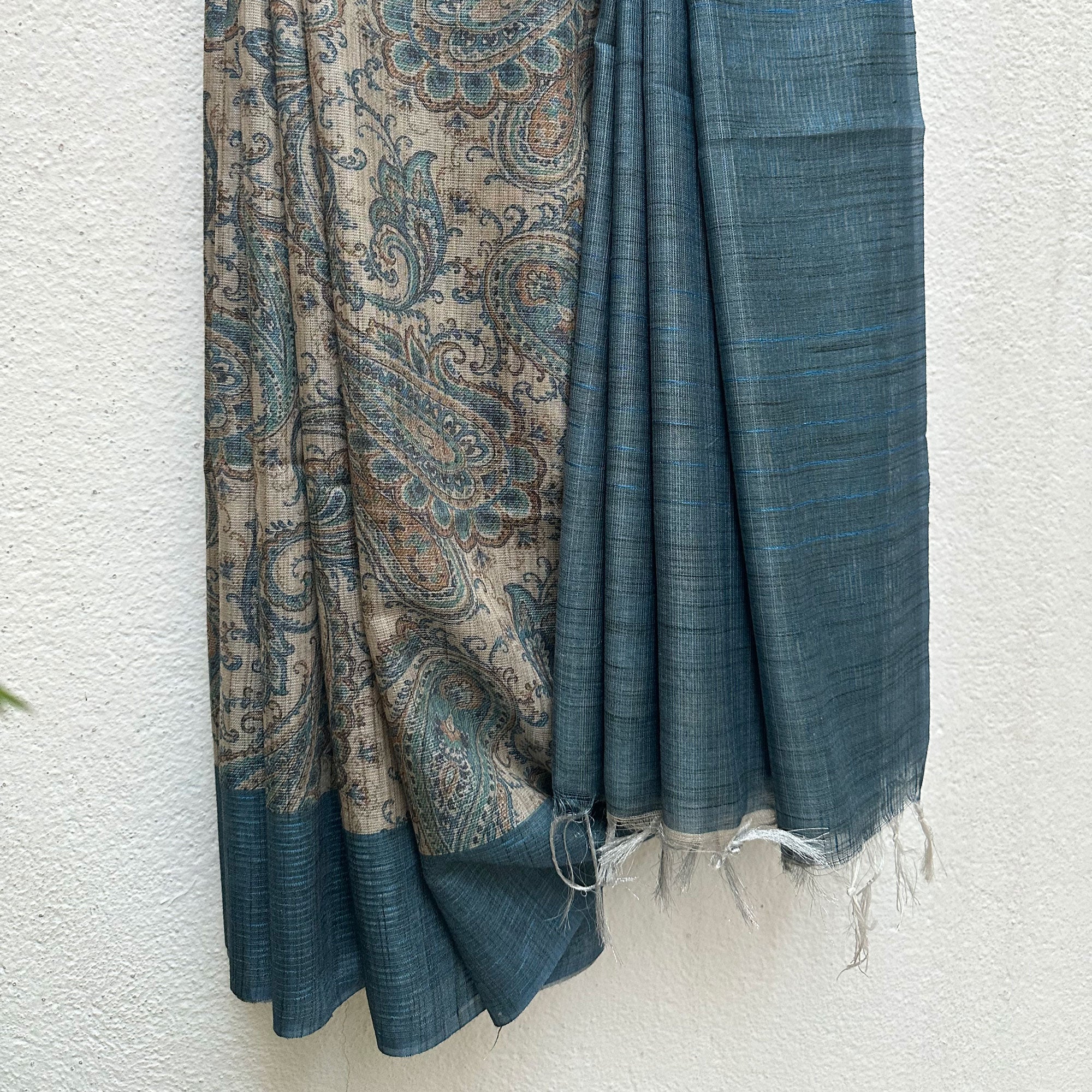 Details of the Ambi tissue silk saree showing the paisley body and solid teal-blue border