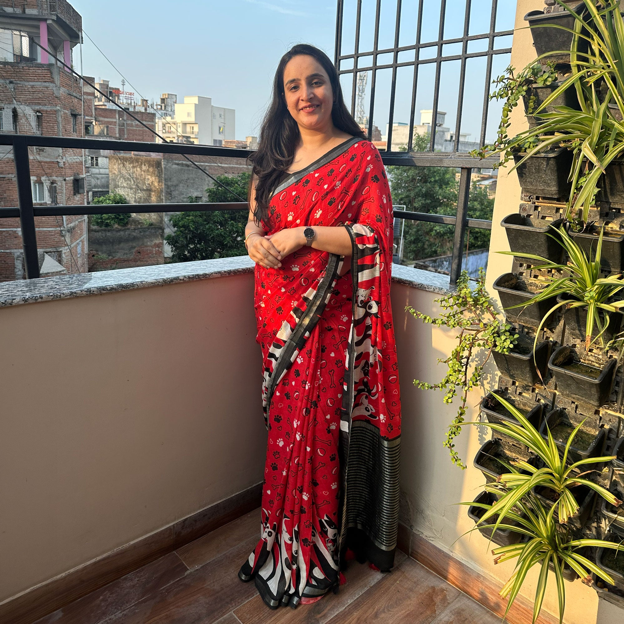 Bone Voyage red cotton dog print saree with paw print and bone motifs, illustrated dog border and black zari stripe pallu, Zoomies Collection