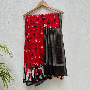 Bone Voyage red cotton dog print saree with paw print and bone motifs, illustrated dog border and black zari stripe pallu, Zoomies Collection