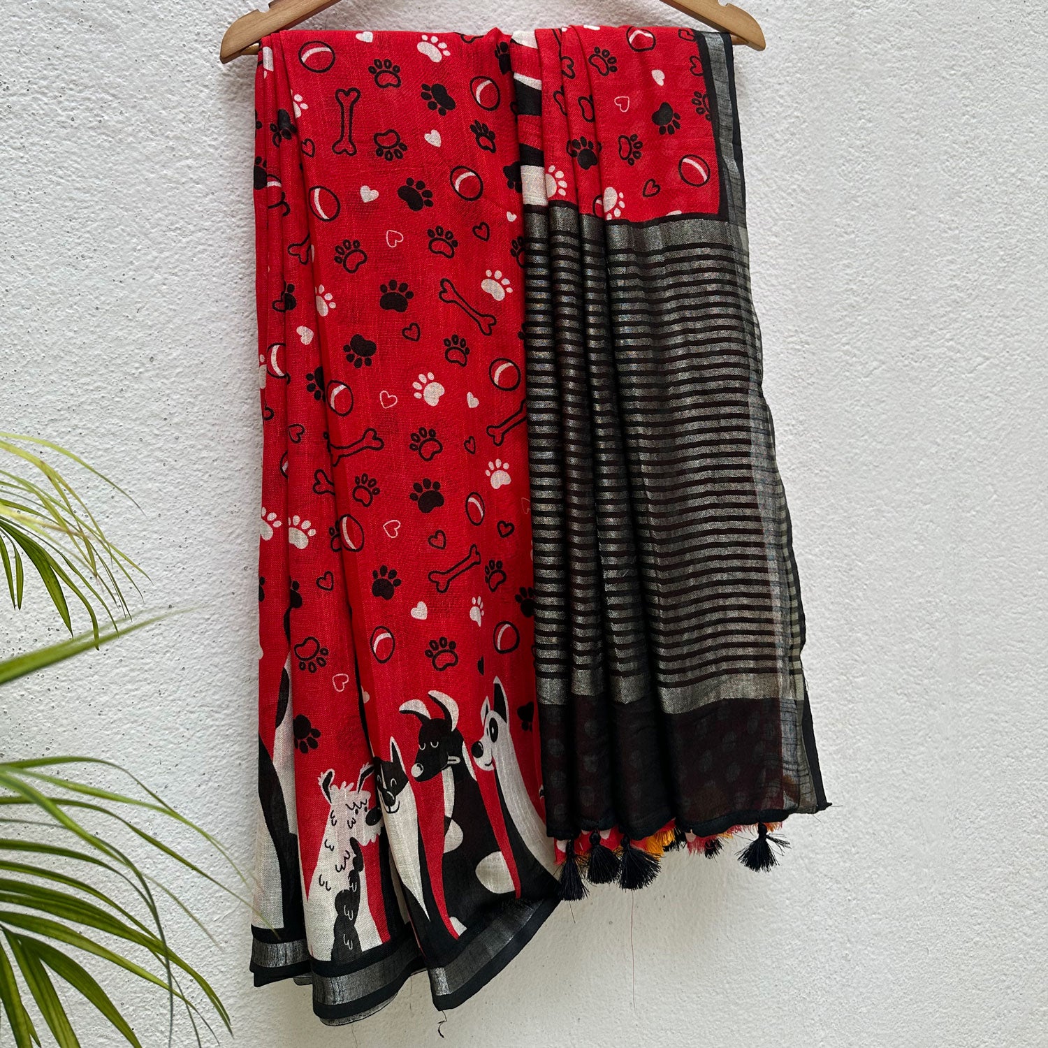 Bone Voyage red cotton dog print saree with paw print and bone motifs, illustrated dog border and black zari stripe pallu, Zoomies Collection