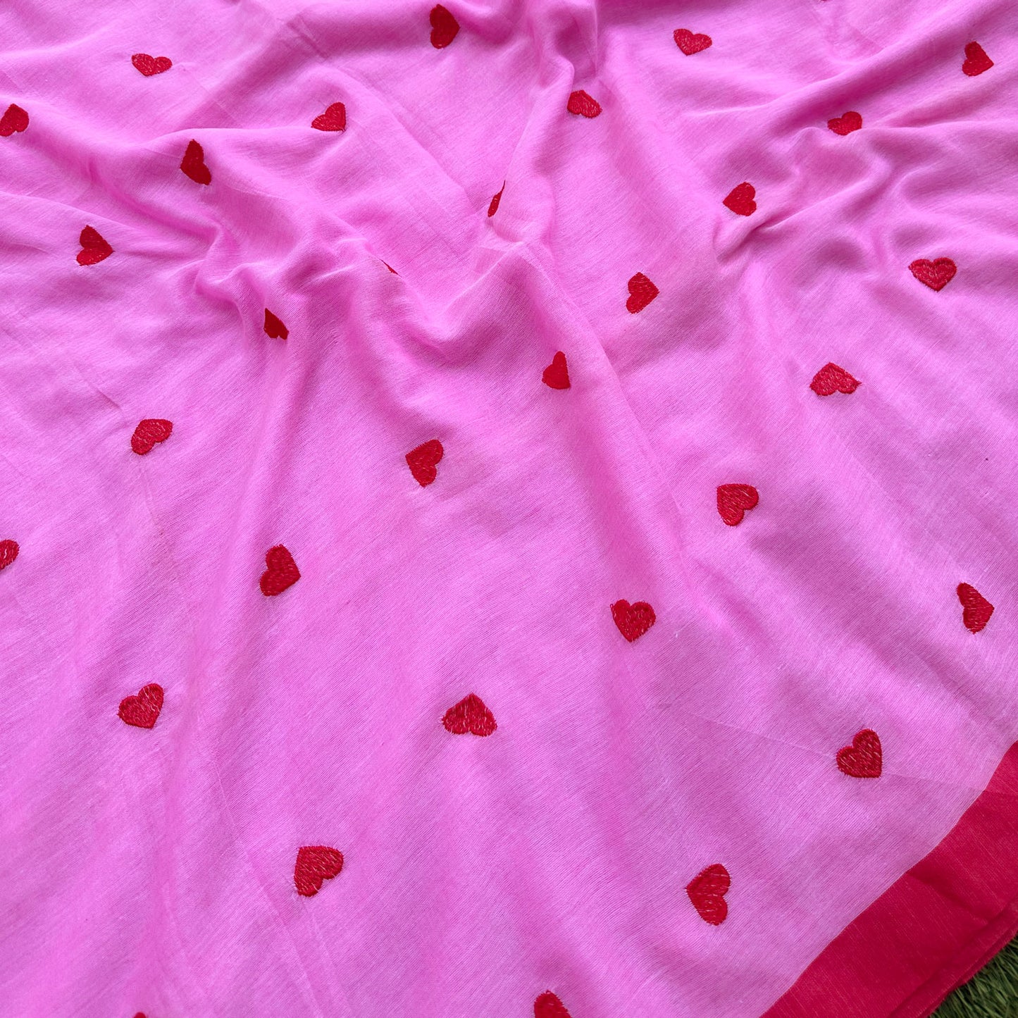 Closeup of Red Hearts Embroidered on Pink Base Saree