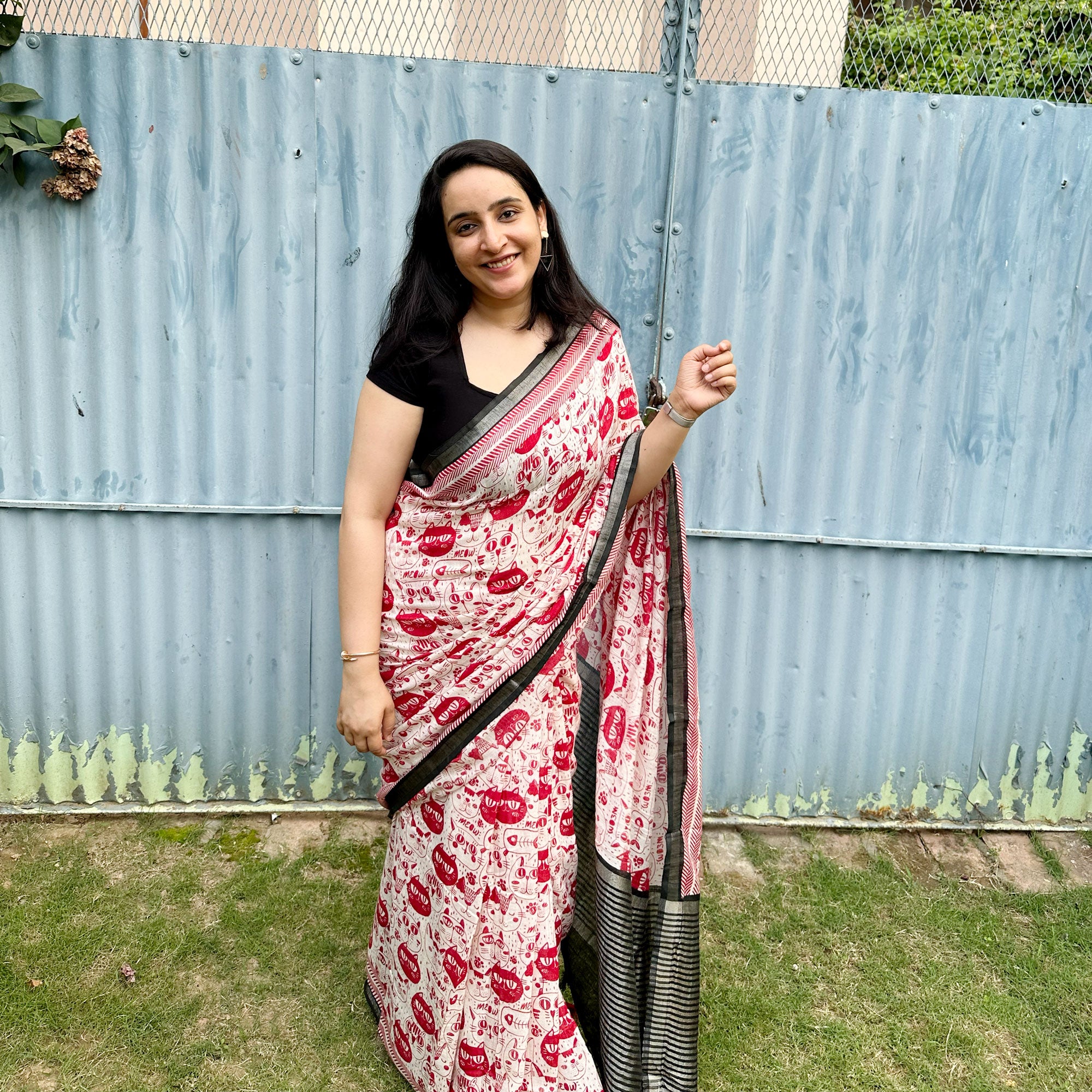 Founder wearing Cat Got Your Heart cotton saree in red and white cat print with black border, styled with black blouse, by The Thread Weavers