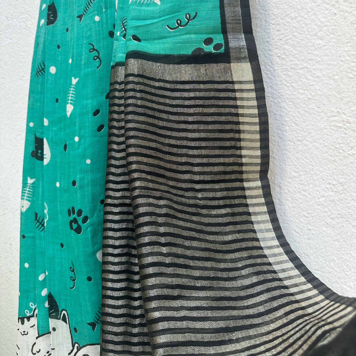 Cat Nap Playtime teal cotton print saree with fishbone motifs, sleeping cat border and black stripe zari pallu, Zoomies Collection