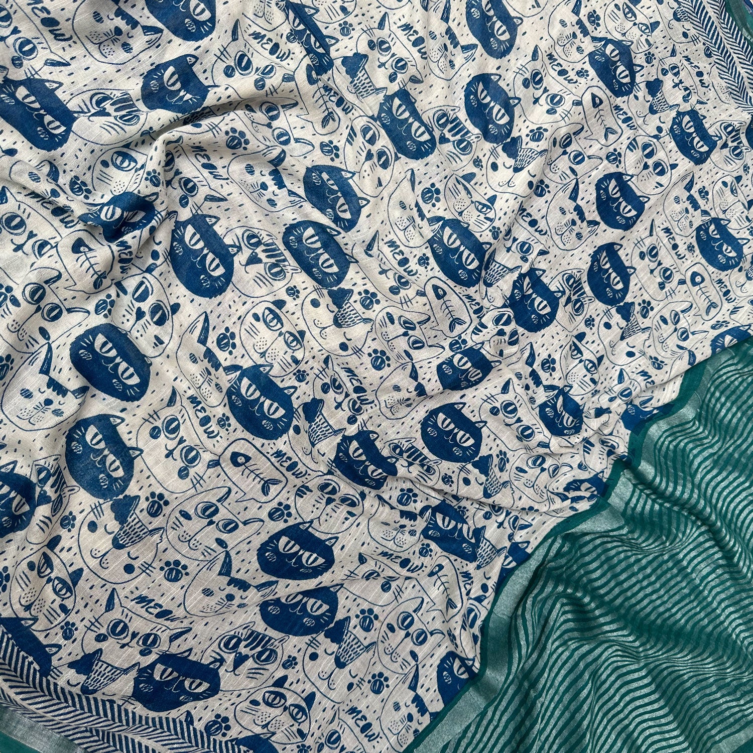 Catsablanca ivory cotton saree closeup with navy meow cat face print, chevron border and teal zari pallu, Zoomies Collection by Thread Weavers
