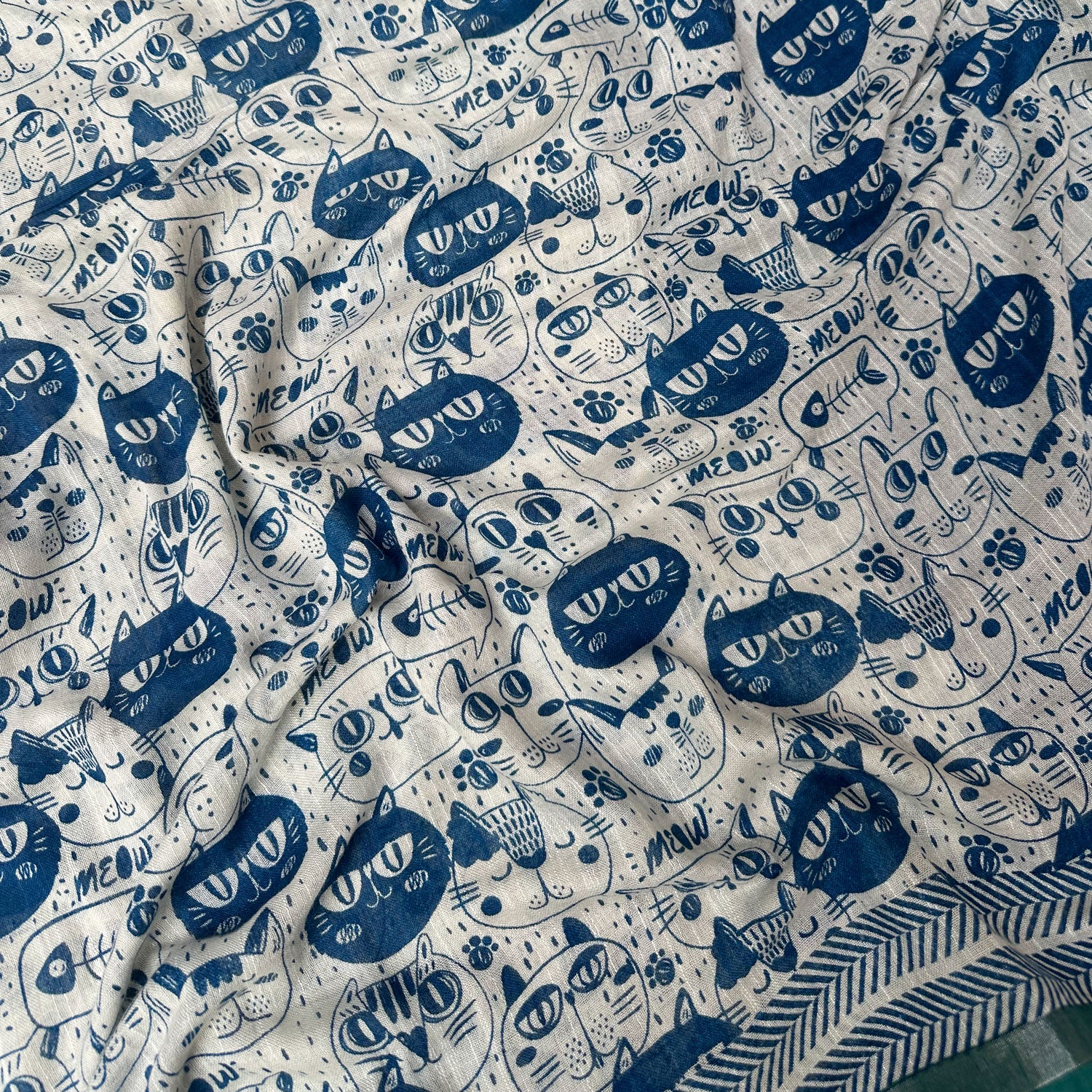 Catsablanca ivory cotton saree closeup with navy meow cat face print, chevron border and teal zari pallu, Zoomies Collection by Thread Weavers
