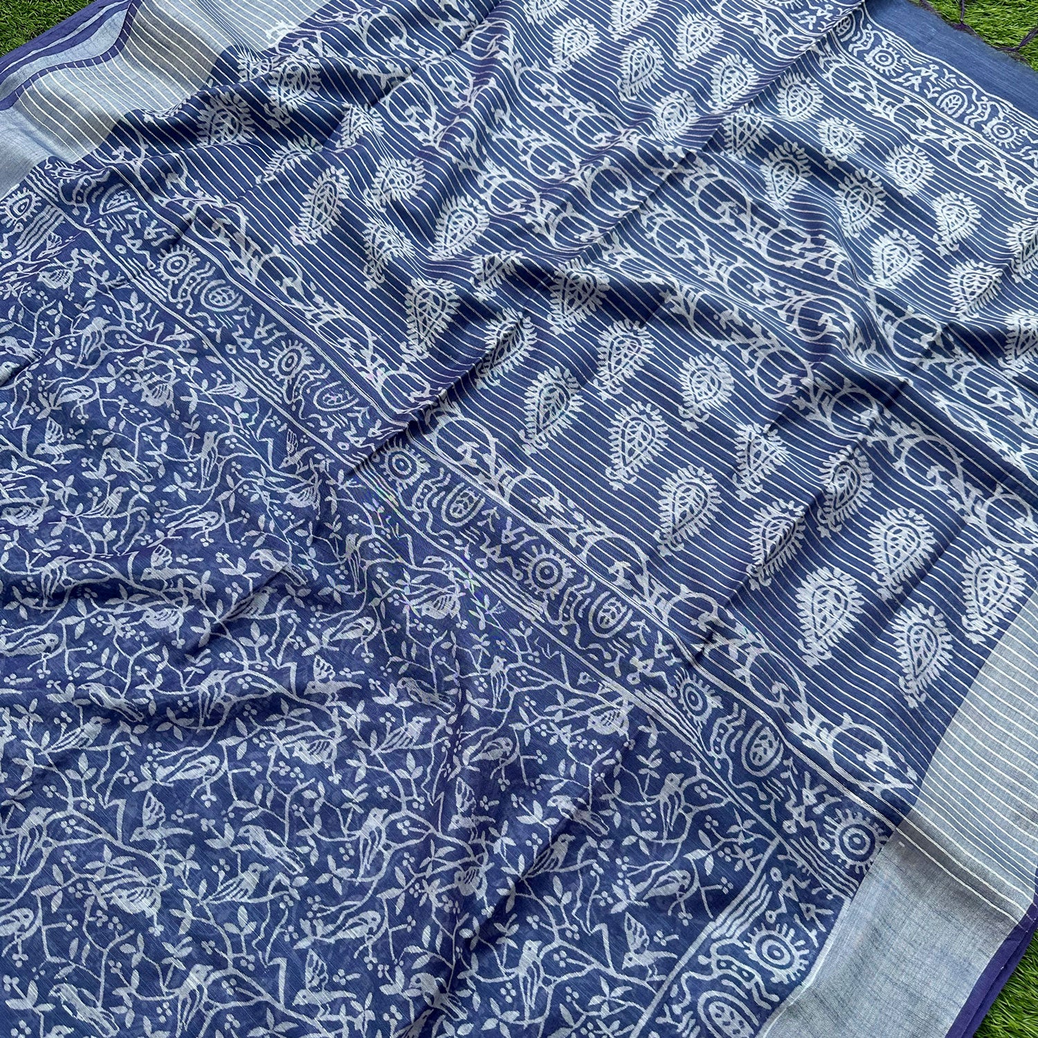 Closeup of Mughal jaal bird and flowering vine block print on indigo cotton silk on the body and paisley on the pallu – Chakori