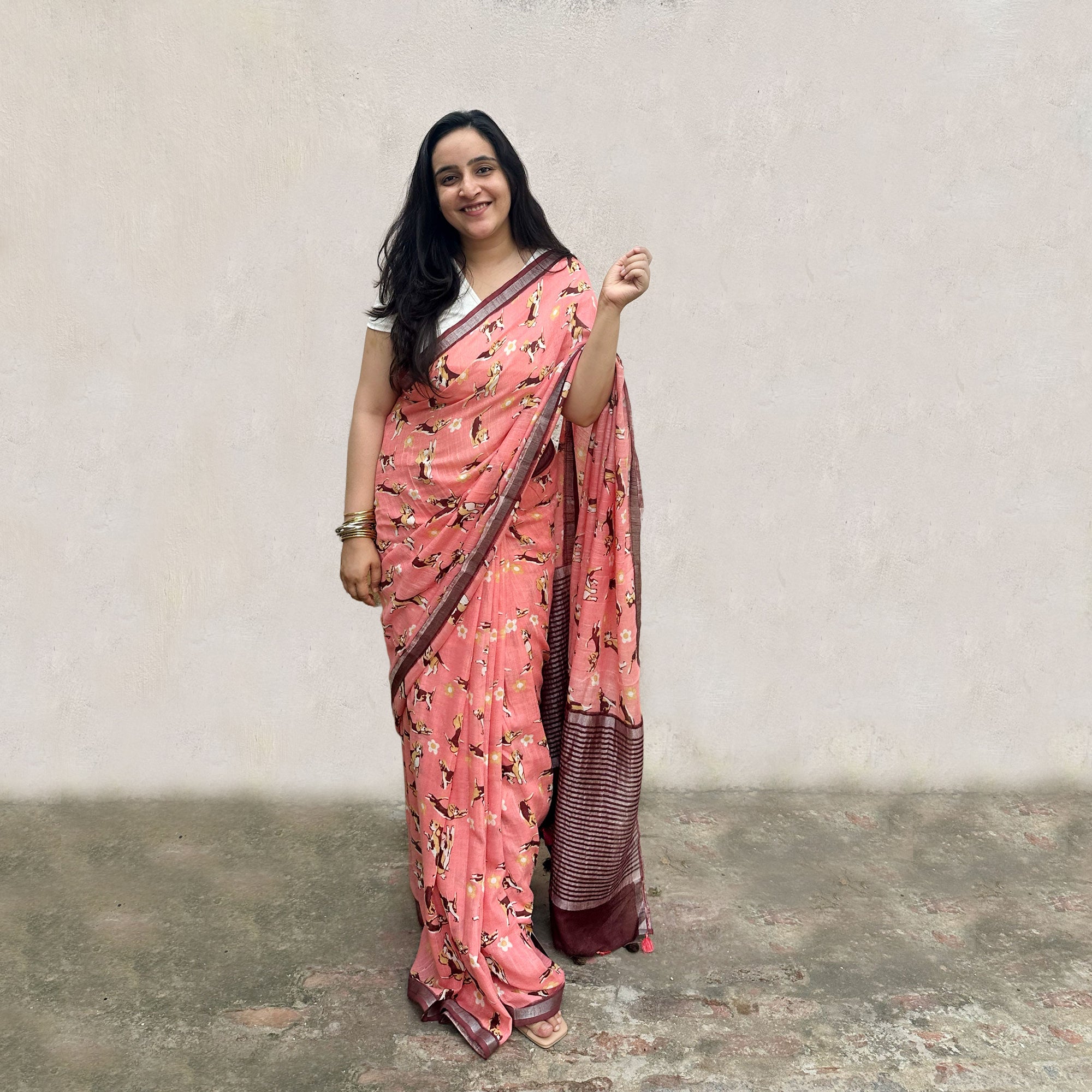 Founder wearing Ears First coral cotton beagle print saree with daisy florals and dark maroon zari pallu paired with white blouse, Zoomies Collection by The Thread Weavers