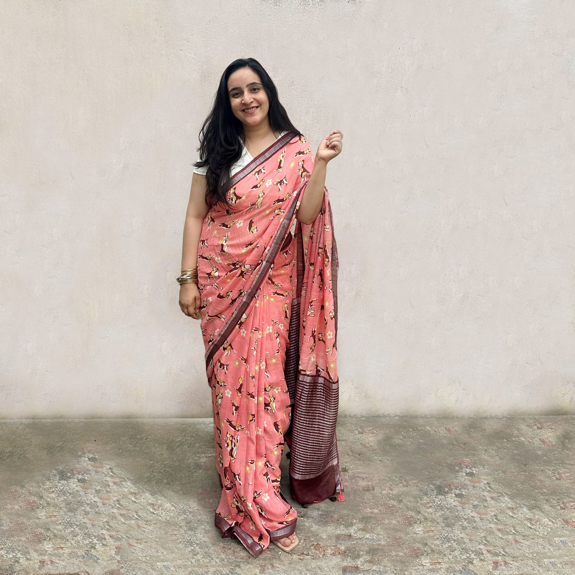 Founder wearing Ears First coral cotton beagle print saree with daisy florals and dark maroon zari pallu paired with white blouse, Zoomies Collection by The Thread Weavers