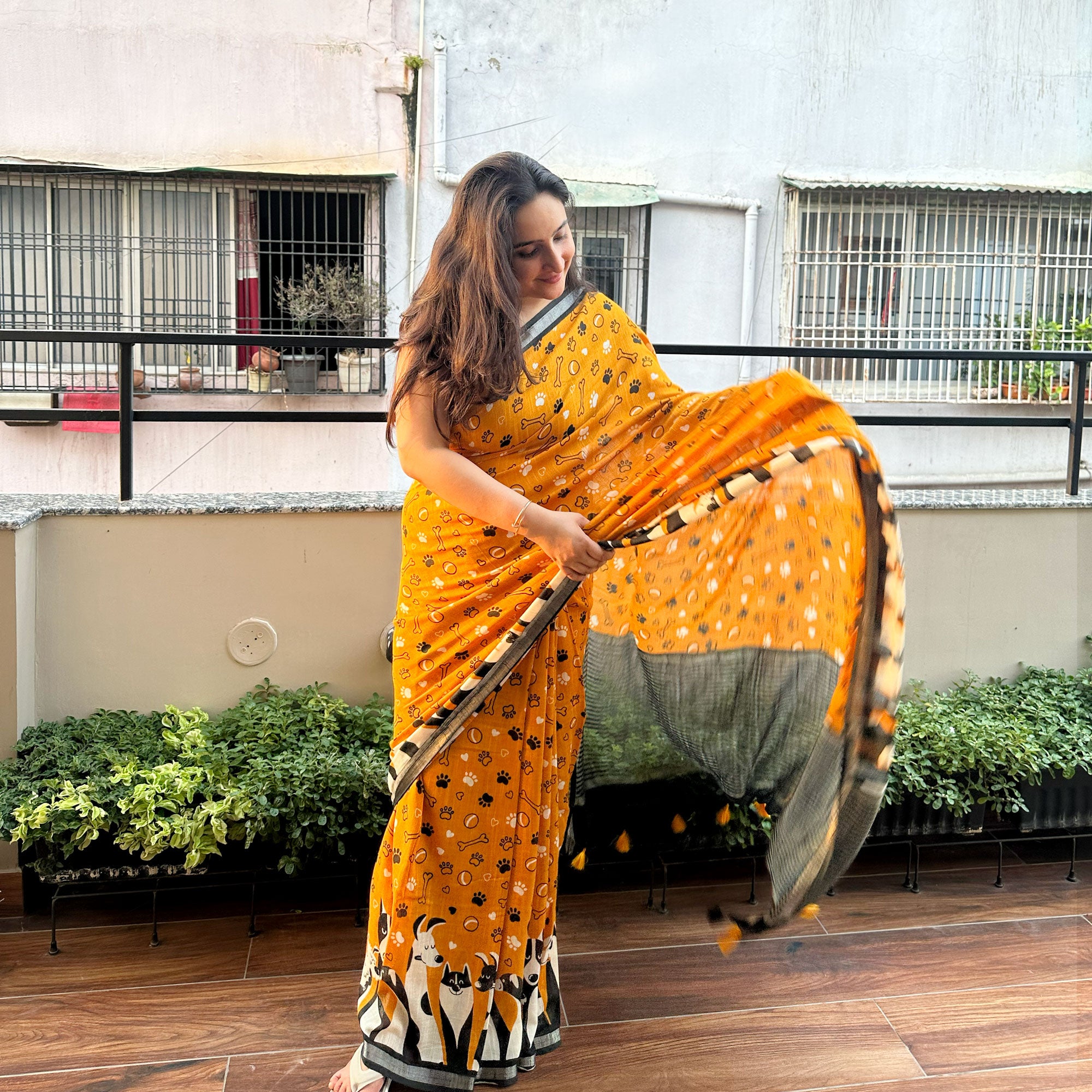 Golden Paws mustard cotton dog print saree with paw print bone motifs, illustrated dog border and black zari pallu, Zoomies Collection