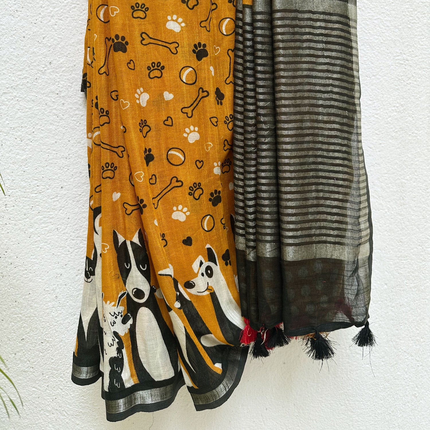 Golden Paws mustard cotton dog print saree with paw print bone motifs, illustrated dog border and black zari pallu, Zoomies Collection