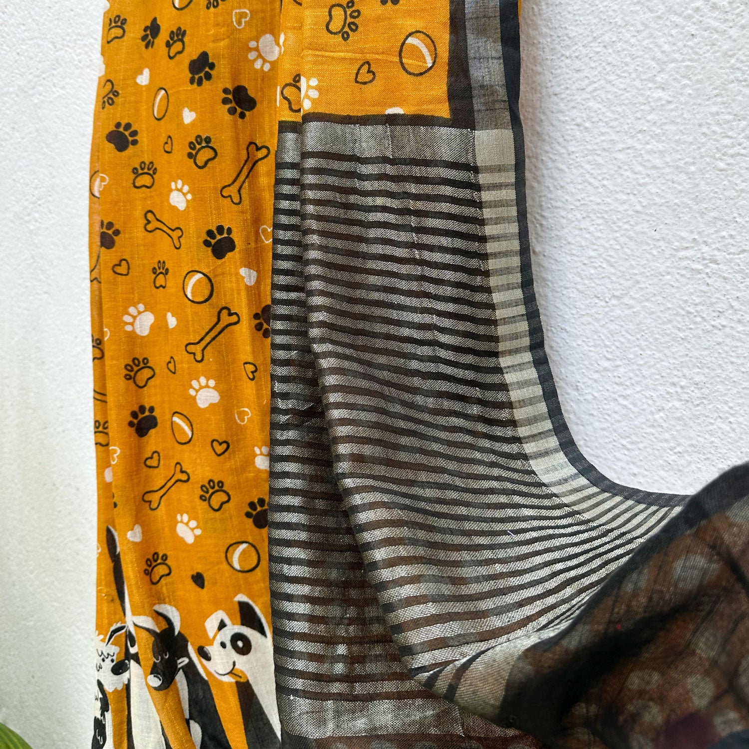 Golden Paws mustard cotton dog print saree with paw print bone motifs, illustrated dog border and black zari pallu, Zoomies Collection
