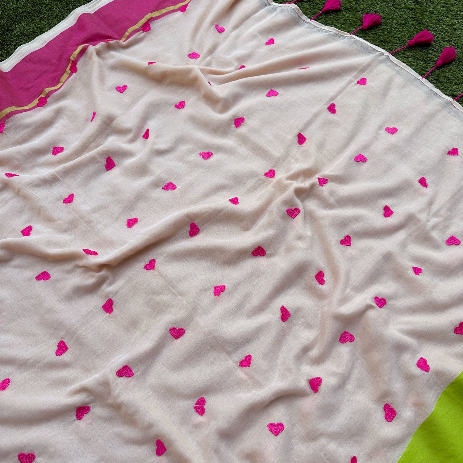 Closeup of mul cotton saree in guava pink and lime green, designed for effortless everyday elegance.