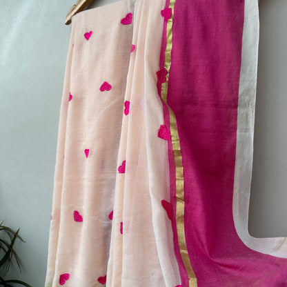Soft blush pink mul saree featuring delicate heart embroidery, Pink and gold border.