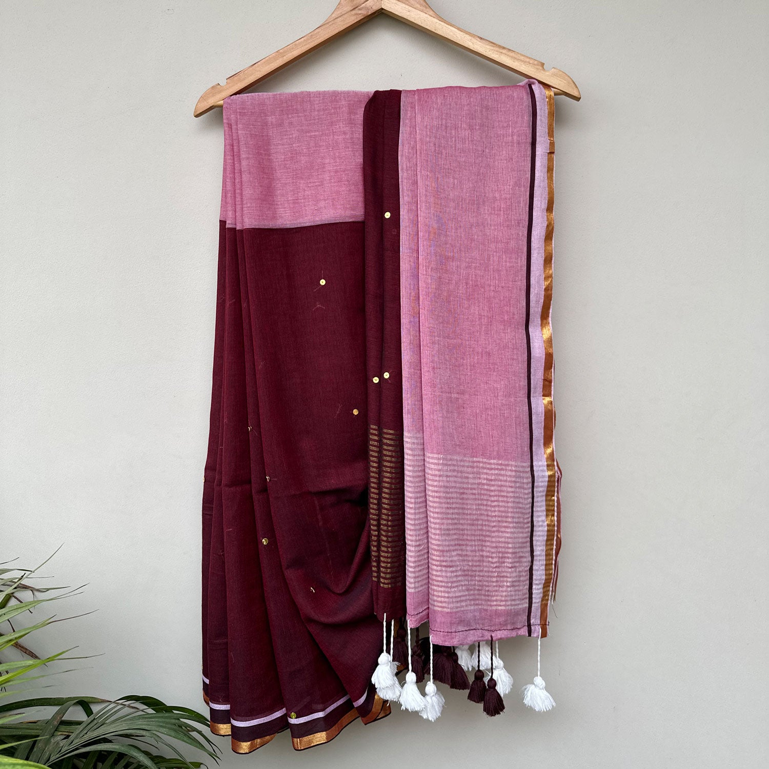Gulaabi Shaam mul cotton saree in deep wine and blush pink with delicate sequin embroidery and handcrafted tassels.