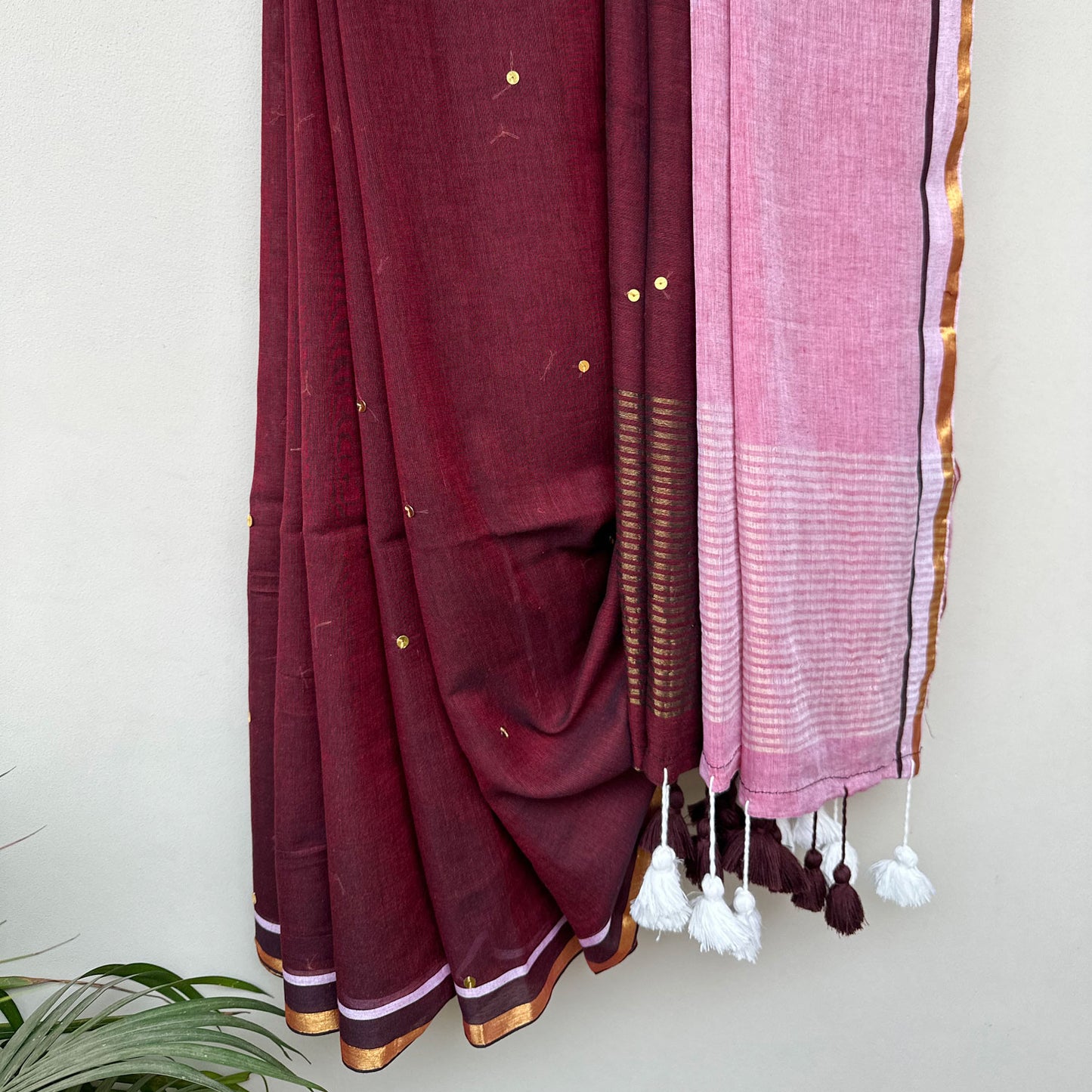 Handcrafted mul cotton saree with delicate sequin embroidery, contrast pink pallu and contemporary Indian design.