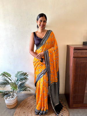Model wearing Zebra Cadabra orange printed cotton saree with zebra motifs and grey border, styled with minimal jewellery and black blouse, by The Thread Weavers
