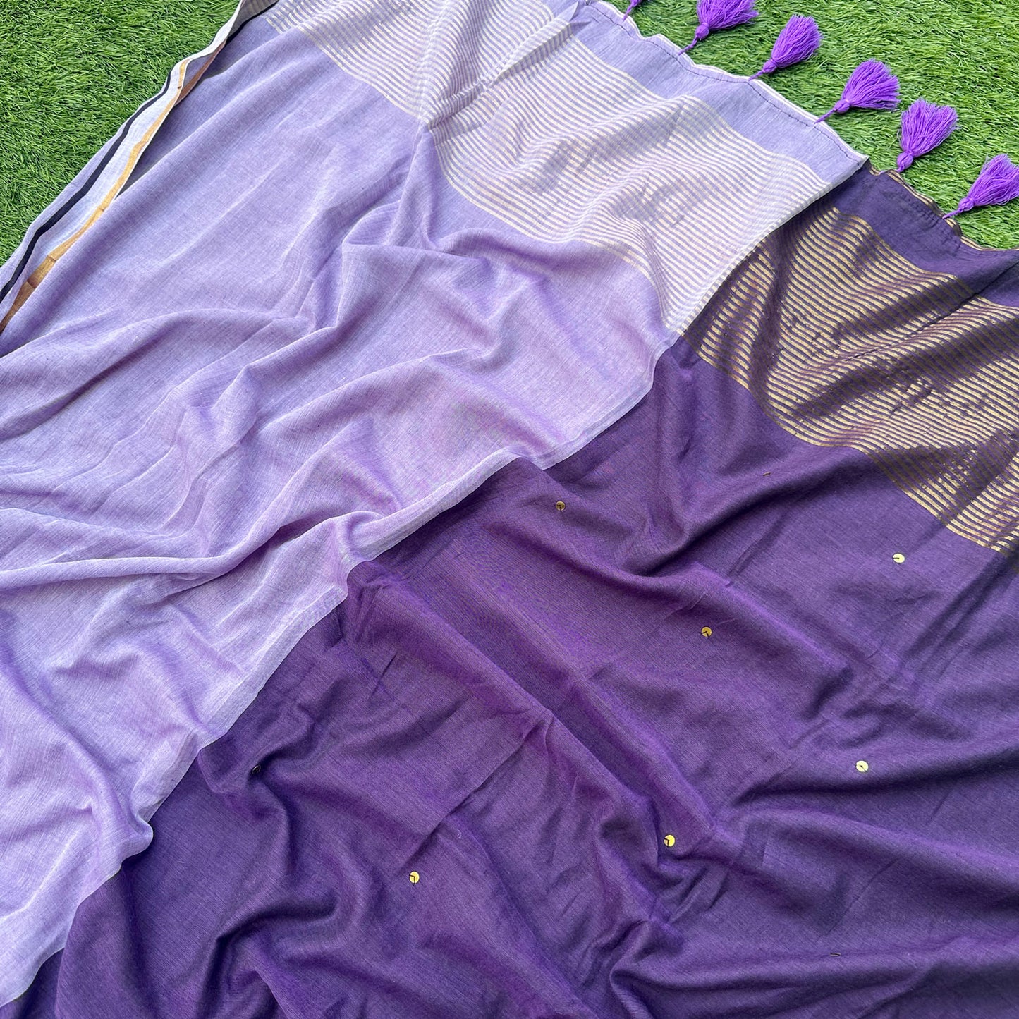 Delicate embroidered motifs on Jamuni Dhoop mul cotton saree in violet and lavender colour palette.