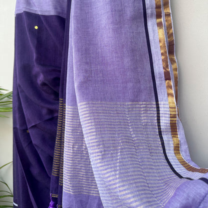 Lightweight embroidered mul saree in violet and lavender tones with striped pallu and tassel accents.
