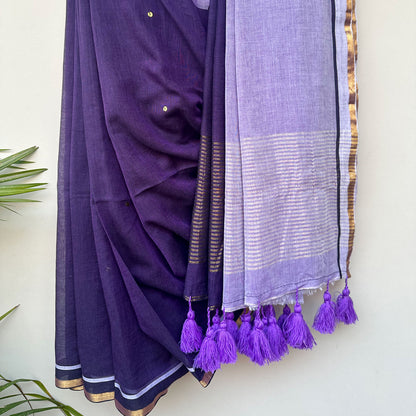 Jamuni Dhoop embroidered saree showcasing an airy mul cotton drape, deep purple hues and handcrafted tassels.
