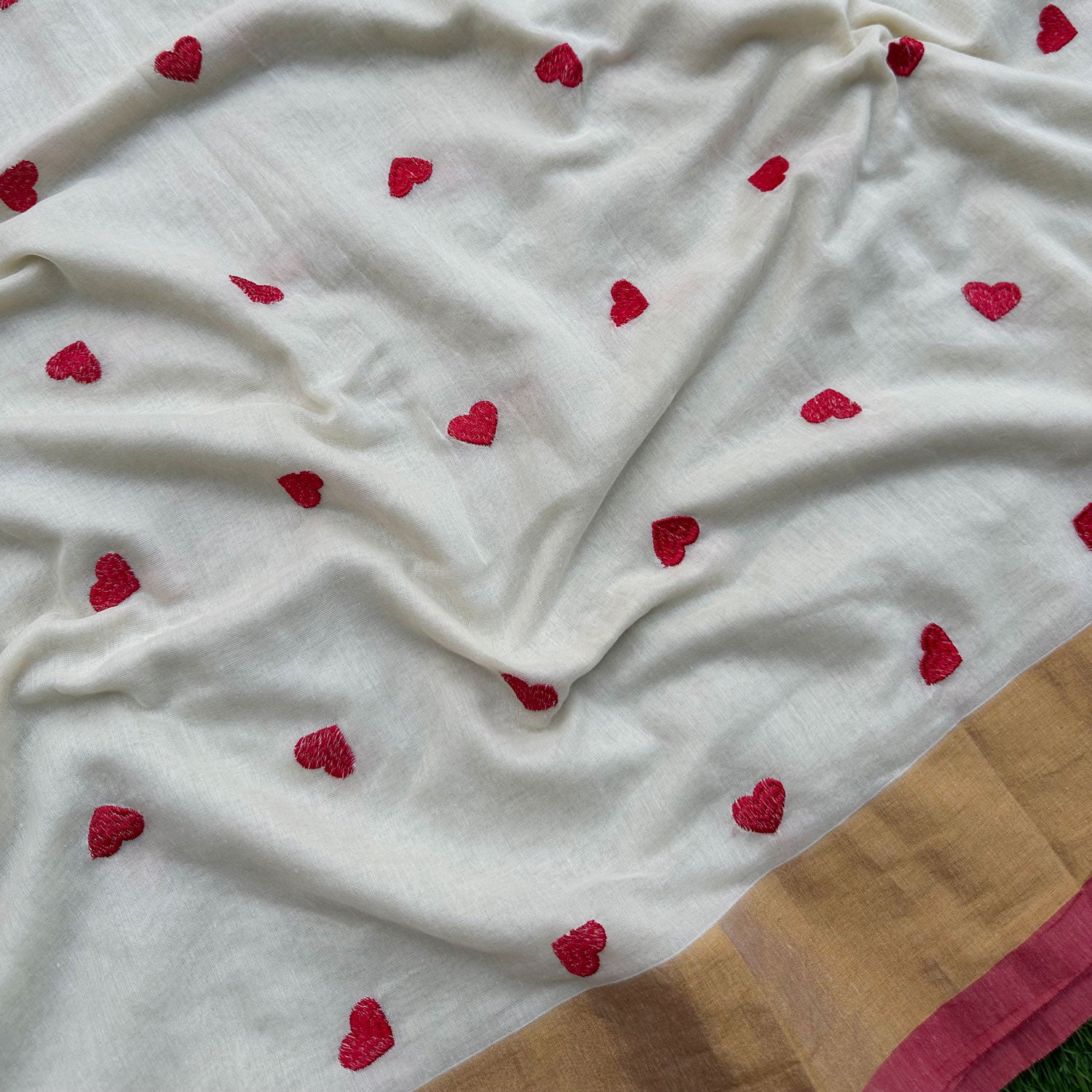 Laal Diary mul cotton saree showcasing playful red embroidery, breathable fabric and handcrafted tassel finish.