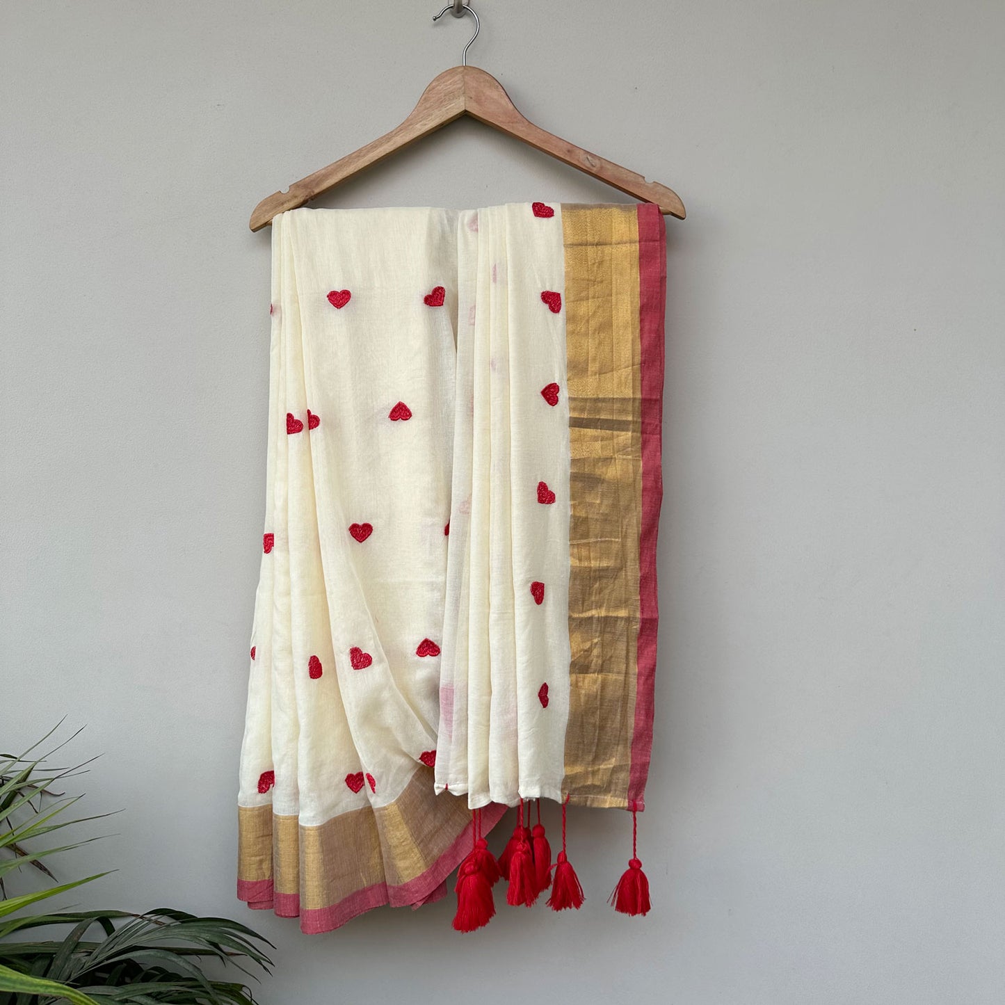 Laal Diary ivory mul cotton saree with red embroidered heart motifs, gold border and handcrafted red