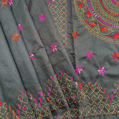 Handcrafted black Kantha saree with intricate circular embroidery, floral motifs and colourful folk-inspired detailing.