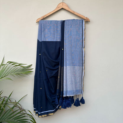 Mul cotton saree in midnight blue with powder blue pallu, delicate embroidery and handcrafted tassels.