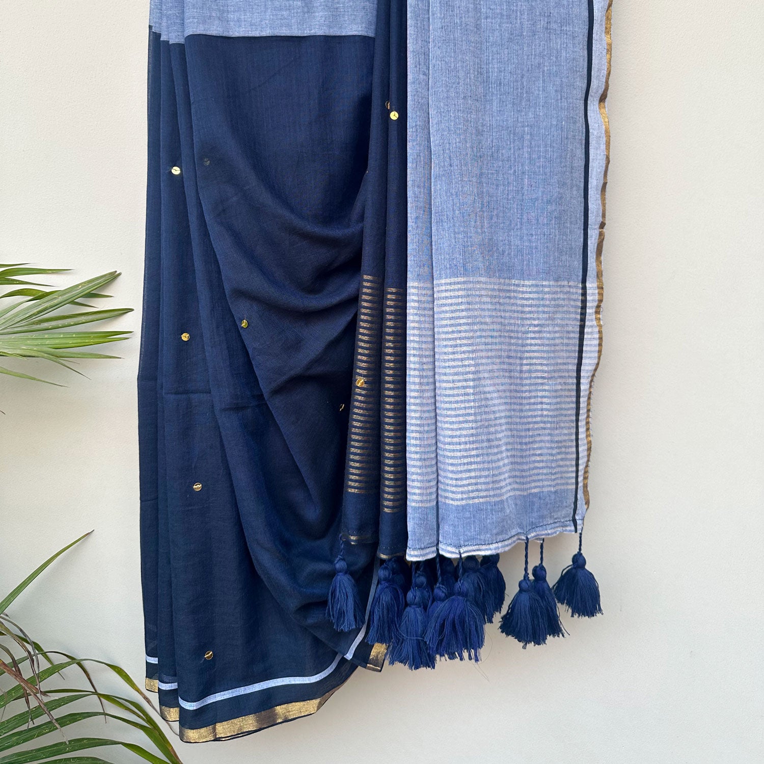 Handcrafted mul cotton saree in contrasting blue tones with embroidered motifs and contemporary Indian styling.