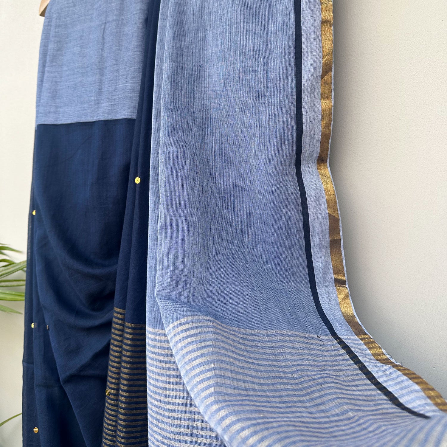 Blue Hour embroidered mul cotton saree showcasing an airy drape, powder blue pallu and artisanal tassels.