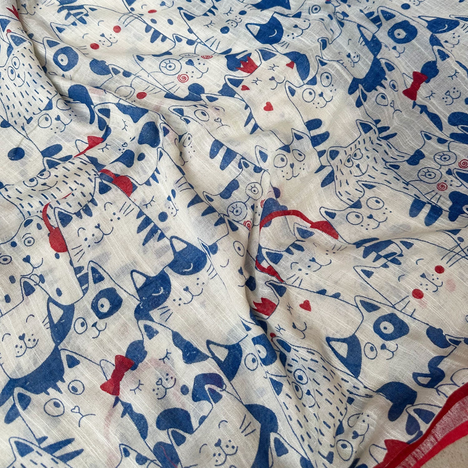 Purr-suasion ivory cotton saree closeup with blue illustrated cat crowd print and bold red zari pallu, Zoomies Collection by Thread Weavers
