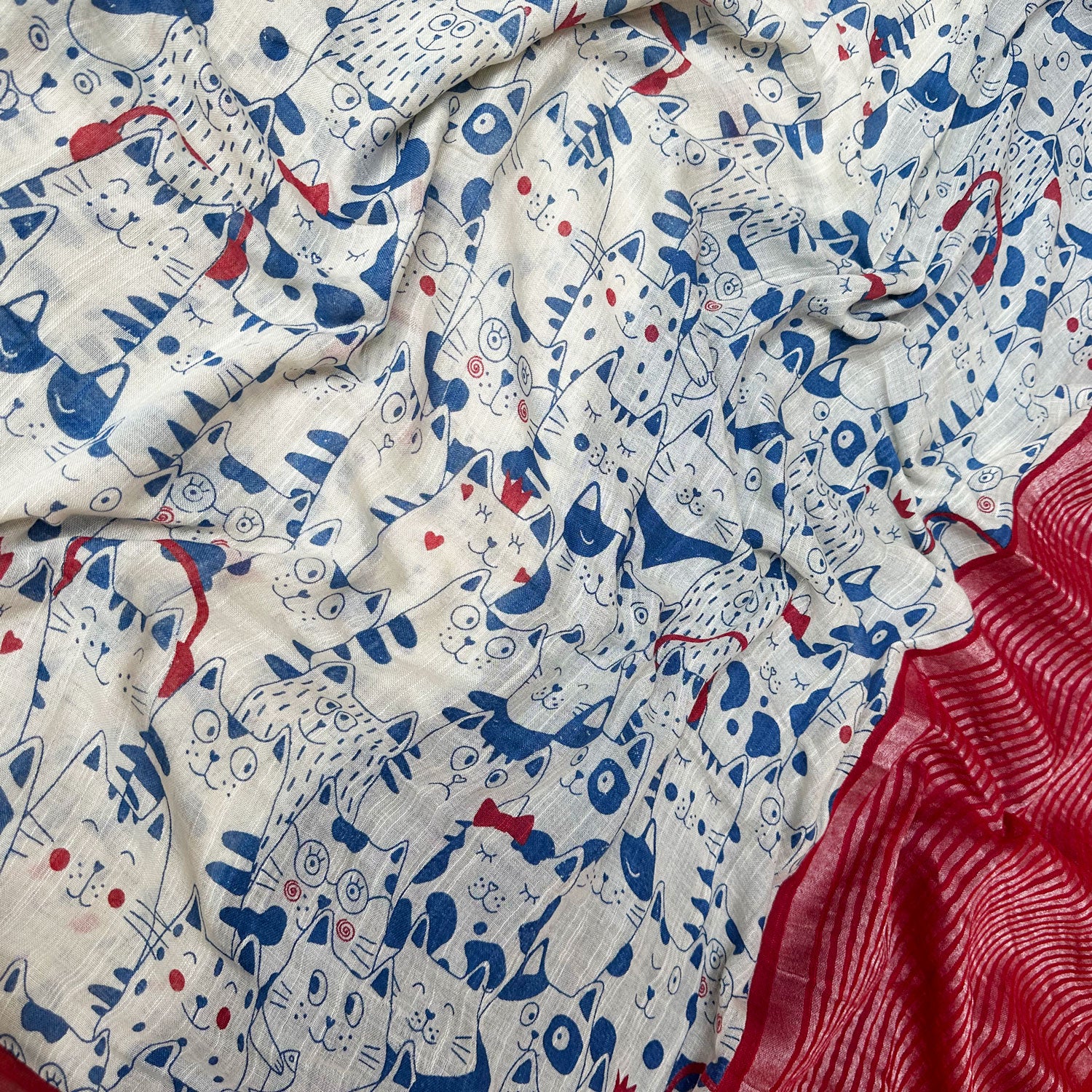 Purr-suasion ivory cotton saree closeup with blue illustrated cat crowd print and bold red zari pallu, Zoomies Collection by Thread Weavers