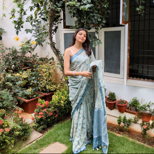 Model wearing The Biscuit Hour sage green cotton beagle print saree with daisy florals and dark teal zari pallu, Zoomies Collection Thread Weavers
