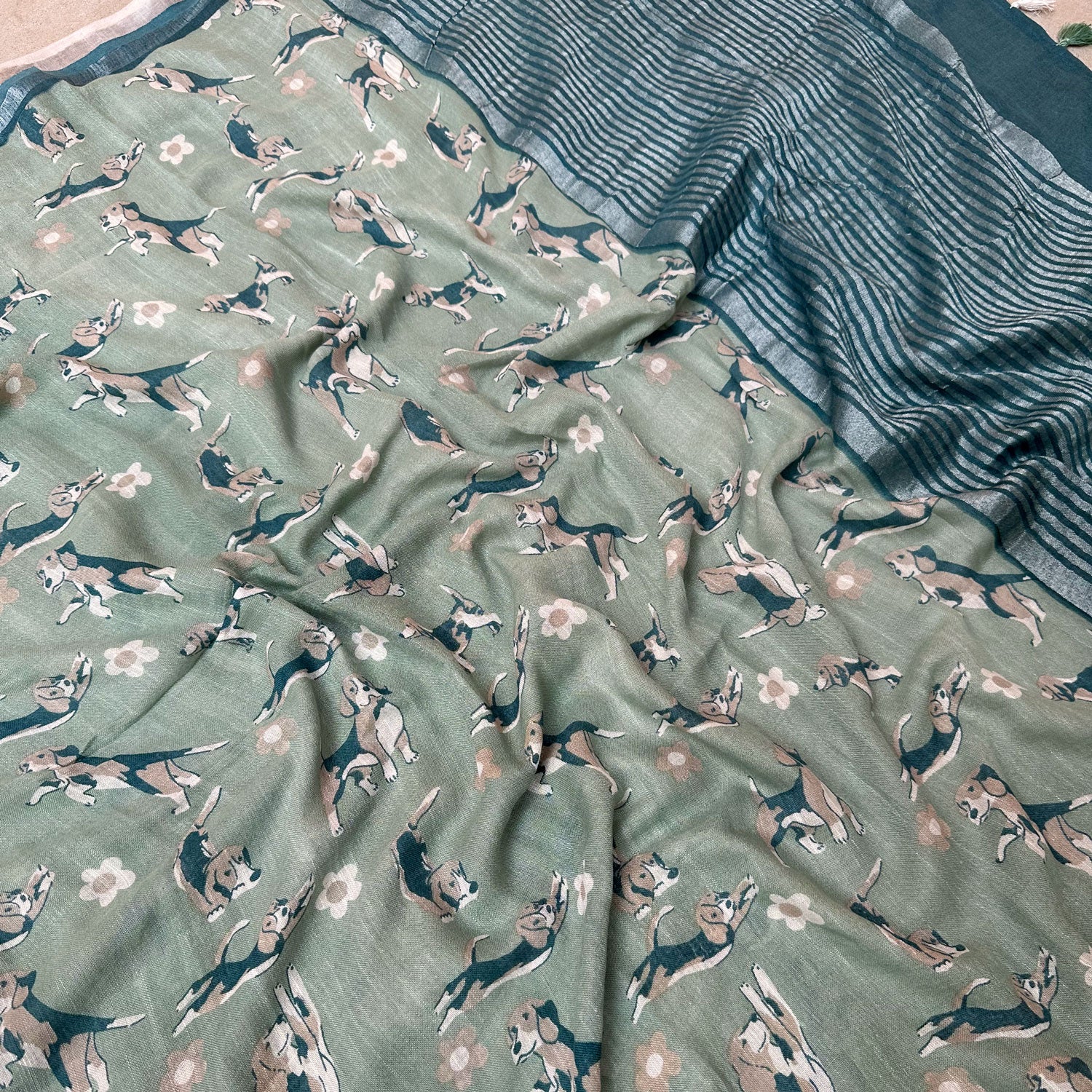 The Biscuit Hour sage green cotton beagle print saree closeup with daisy florals and dark teal zari pallu, Zoomies Collection Thread Weavers